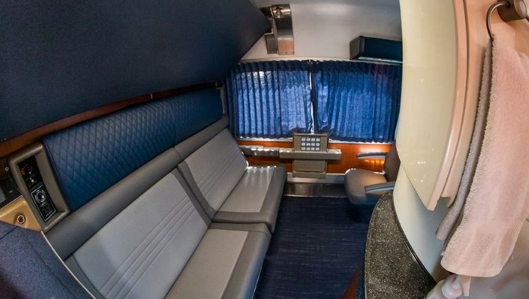A Bedroom set up for day use, the sofa is folded flat to create the lower berth