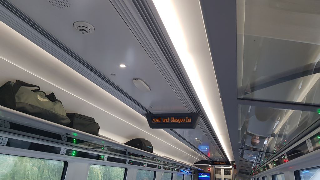 Note the green and red lights which are beside the seat numbers above the windows on this British train