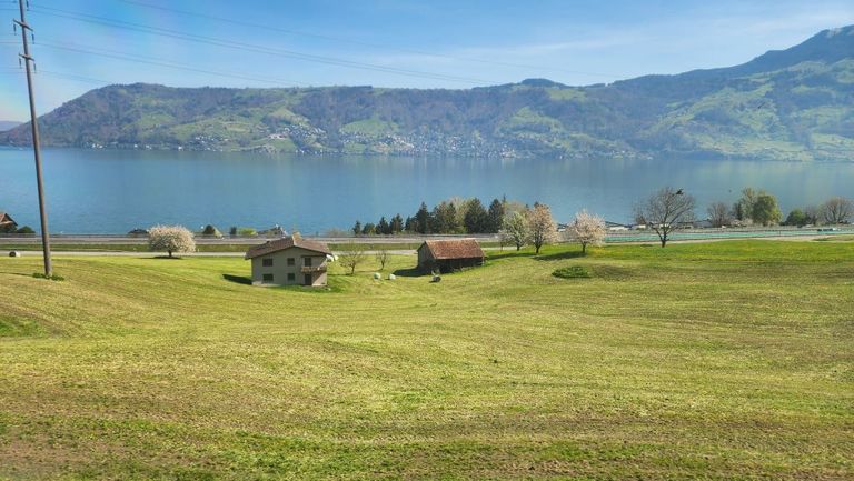 Travelling by the stunning Lake Zug on the train between Basel and Lugano