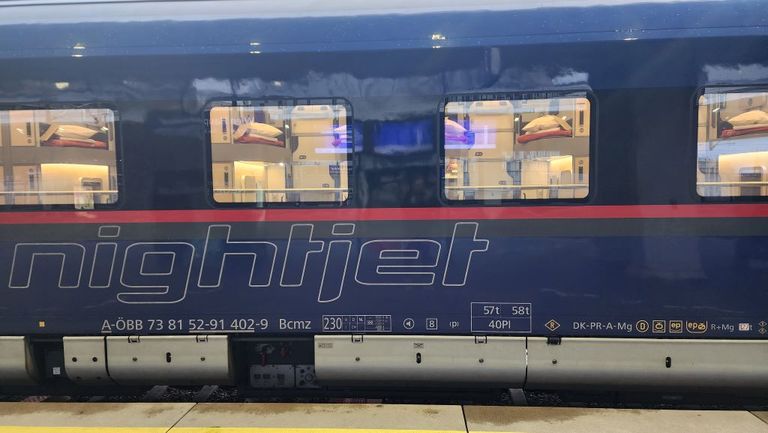 Mini cabin capsules with their doors open ready for boarding on a New Generation Nightjet train.