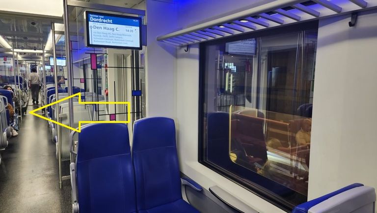 The arrow added to the image is showing that boarding simply involves walking on to the train. Note that most of the seats are also on this level.