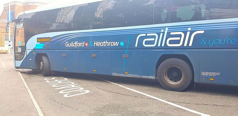 A RailAir bus on the Guildford to Heathrow route arrives at Woking